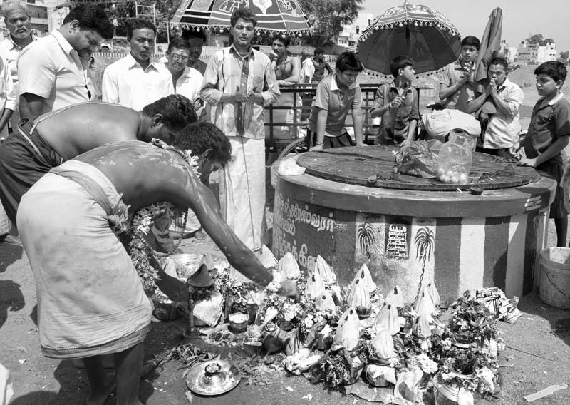 Challenges Impacting the Connection between Water and Religion - Rituals being performed during Aadi month near a temple well in the dried-up bed of sacred Vaigai river in Madurai, Tamil Nadu